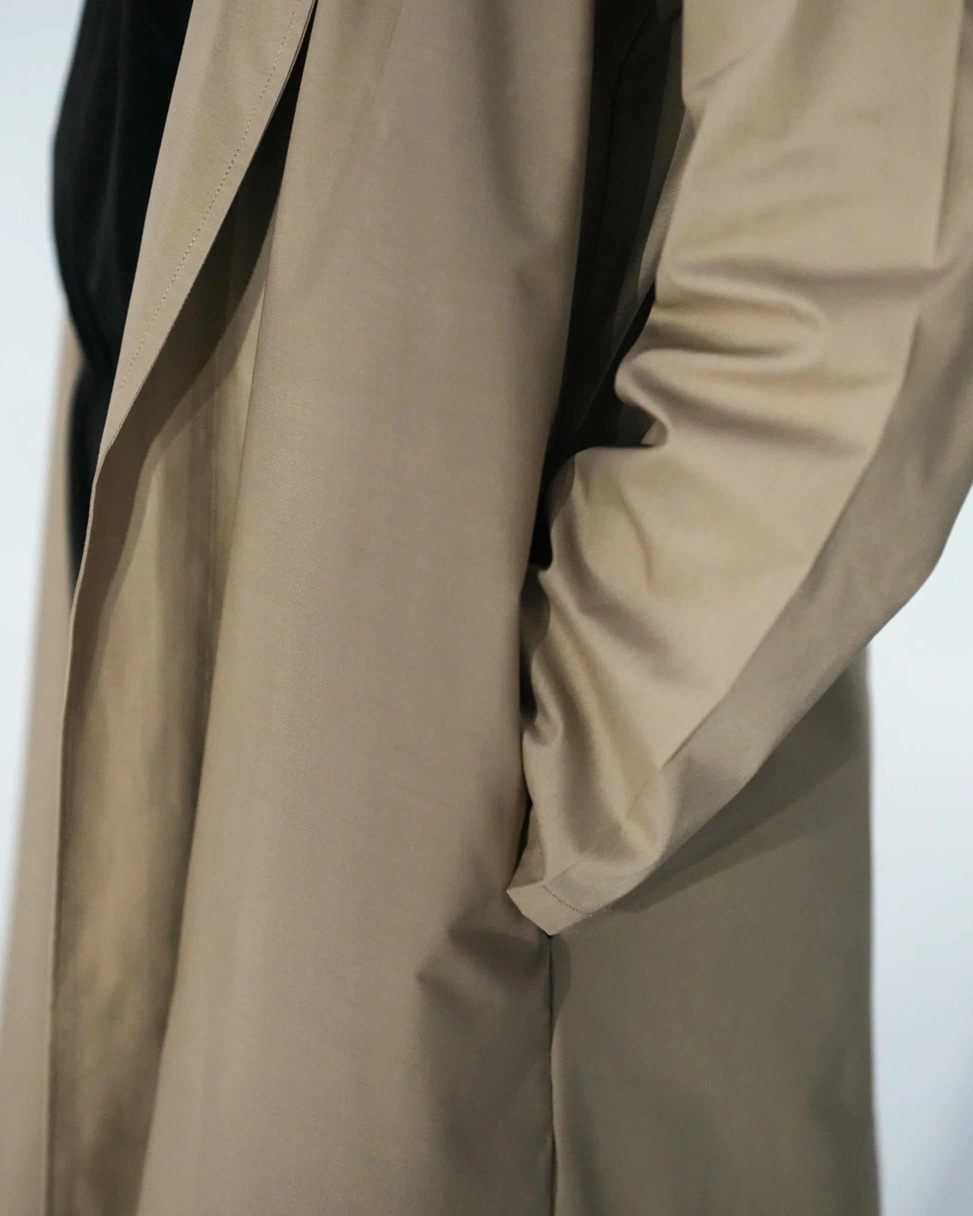 Pocket detail of beige open front abaya for women