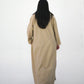 Back view of beige long coat abaya with modest full length drape