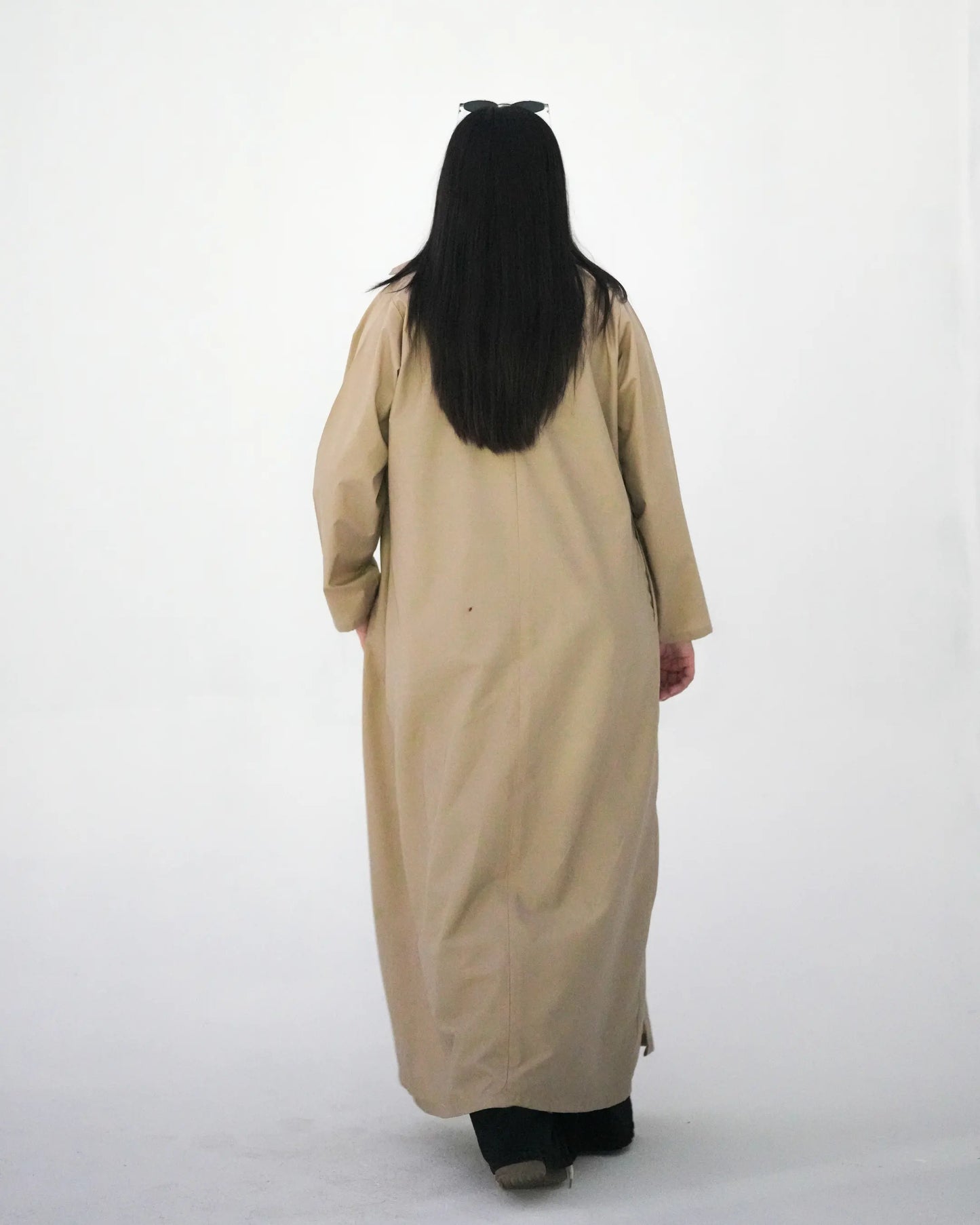 Back view of beige long coat abaya with modest full length drape