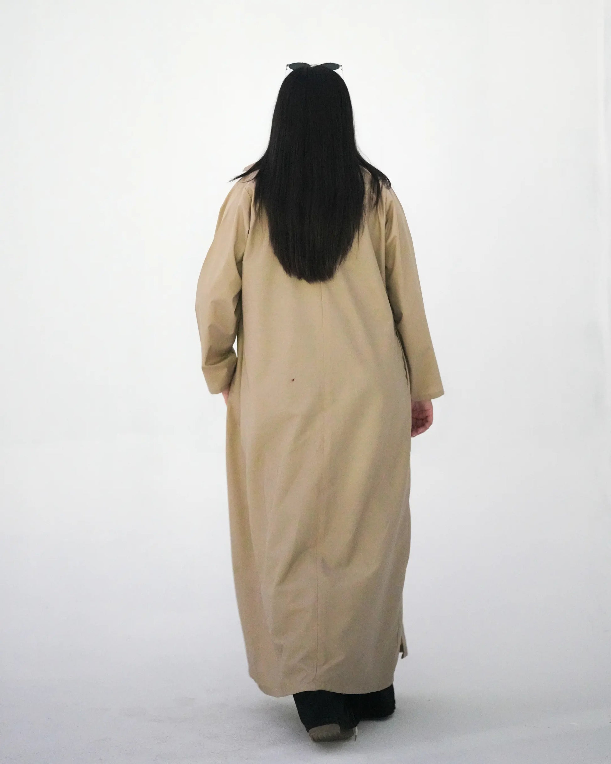 Back view of beige long coat abaya with modest full length drape