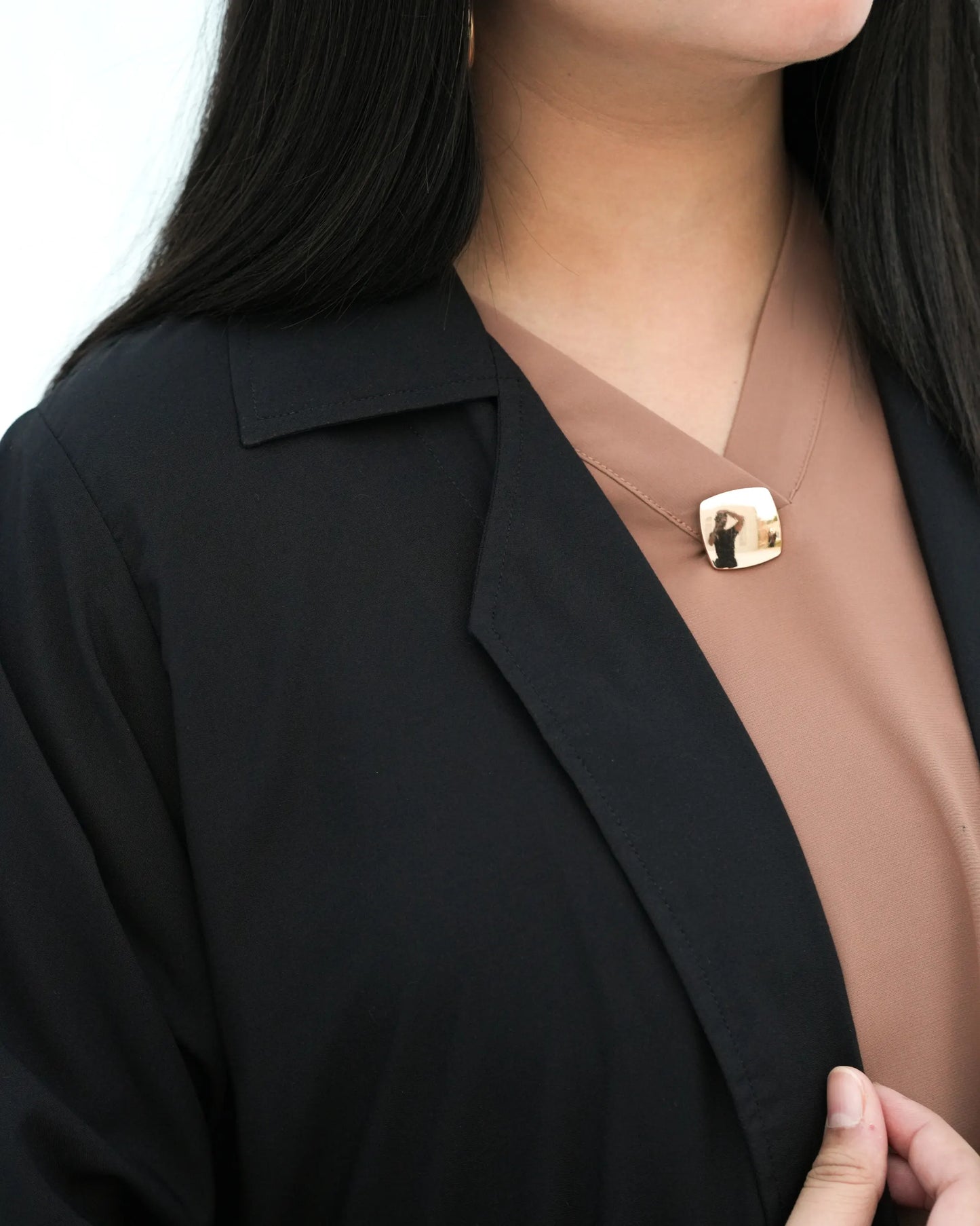 Close up showing the structured collar and clean neckline finish.