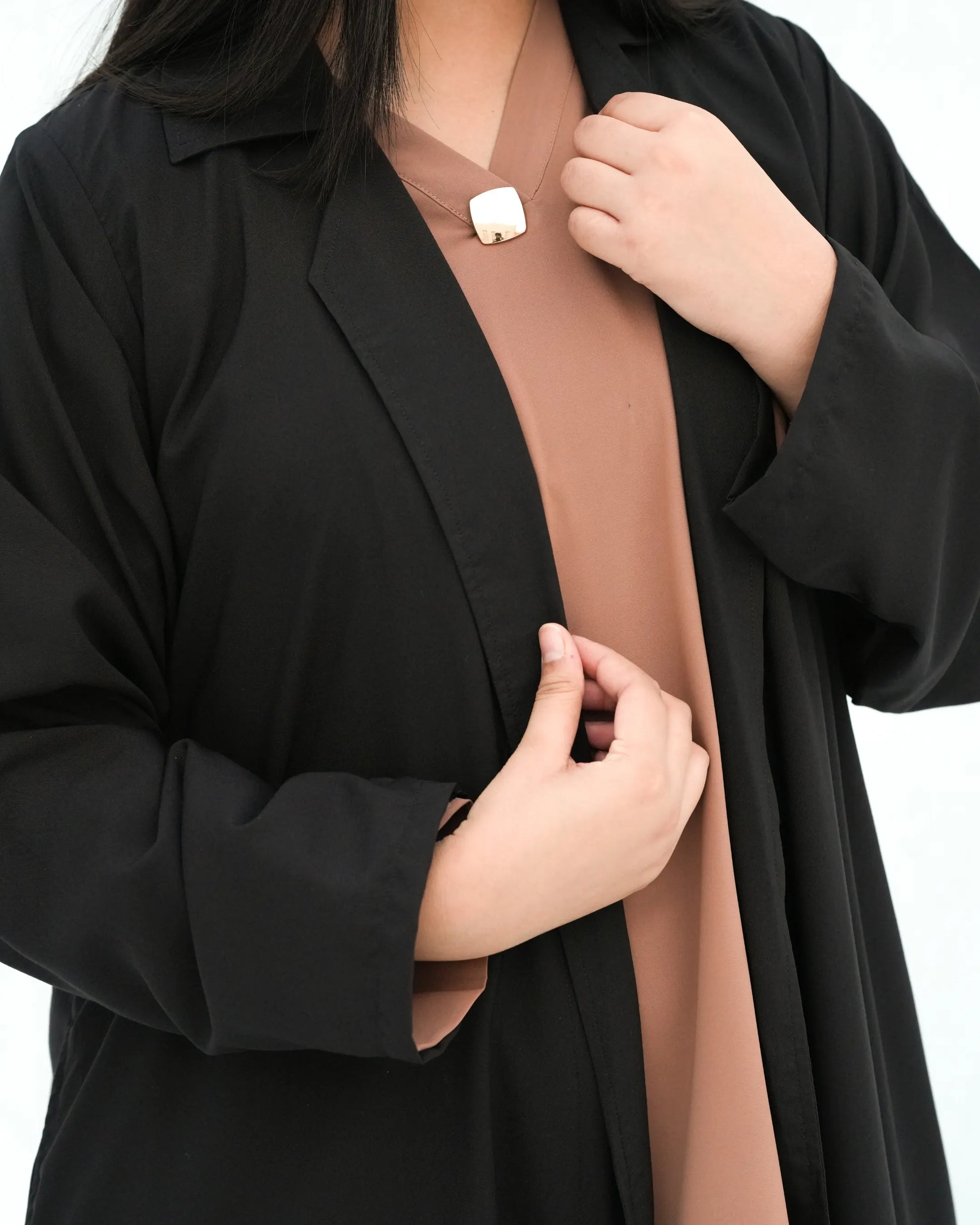 Close up of black abaya collar and front opening